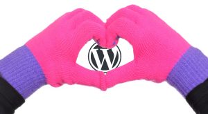 child making heart symbol with gloves on